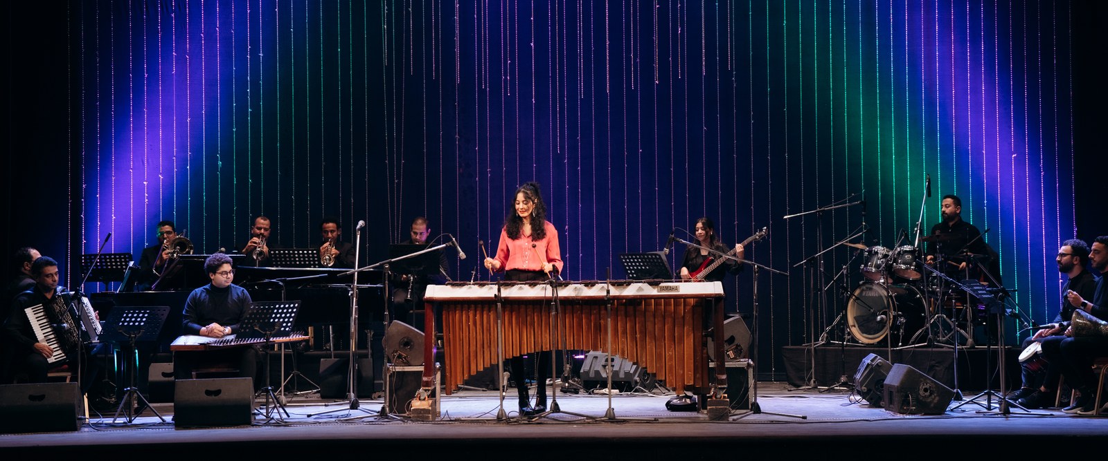 Nesma playing marimba on stage with her ensemble